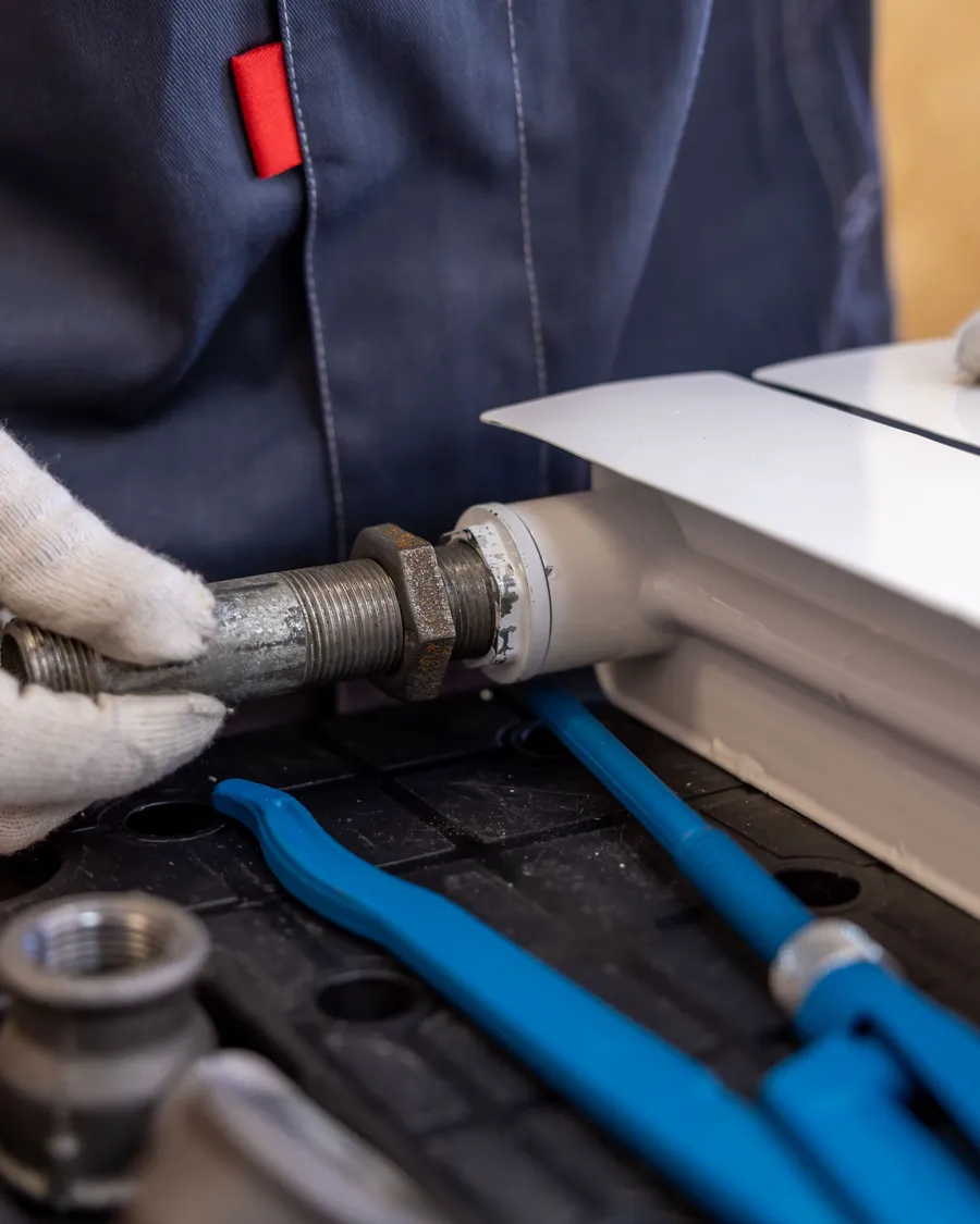 Emberley's Plumbing professional at work on a pipe installation